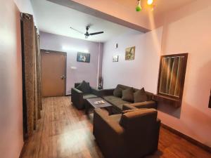 a living room with a couch and a table at Hotel Sintle Palace in Bhubaneshwar