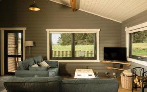 a living room with a couch and a tv at Cateran Rest in Kirkmichael