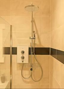 a shower with a shower head in a bathroom at Cateran Rest in Kirkmichael +4 photos