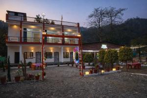 a large building with a lot of tables and chairs at Forest Nest Farm Stay in Rājpur