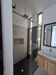 a bathroom with a glass shower and a sink at El Ensueño - Rest House in La Mesa +32 photos