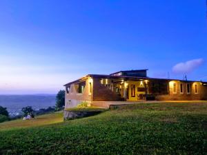 a house on top of a grassy hill at night at Solar de Bonito in Bonito