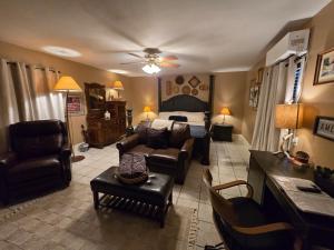 a living room with a couch and a bed at Roots Retreat in Seymour