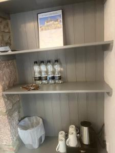 a shelf with bottles of water in a kitchen at St Olaf Golf Hotel in Cruden Bay