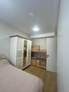 a bedroom with a bed and an open door at Cozy apartment for a comfortable vacation in Itʼkhvisi
