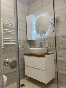 a bathroom with a sink and a mirror at Cozy apartment for a comfortable vacation in Itʼkhvisi +13 photos