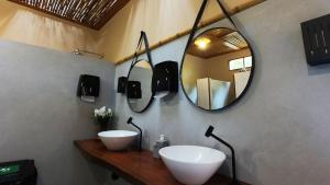 a bathroom with two sinks and a mirror at Glamping in Lavrinhas
