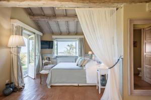 a bedroom with a white bed and a window at Dimora Santa Margherita - Boutique Hotel in Cinigiano +118 photos
