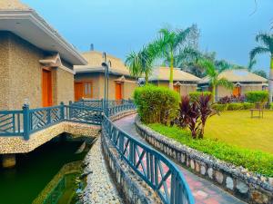 a house with a bridge over a body of water at MJ Funcity Water Park & Resort in Lucknow +19 photos