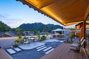 a patio with chairs and tables on a roof at Fenghuang Story Hotel in Fenghuang County