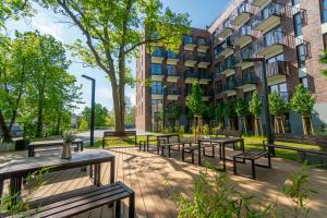 a group of benches in front of a building at Silver Forest in Szczecin