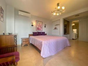 a bedroom with a large bed with a pink bedspread at Villa Maja in Sutomore