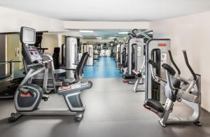 a gym with a row of cardio machines at Millennium Taiba Hotel in Medina