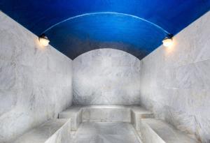 a room with a blue ceiling and stone walls at Millennium Taiba Hotel in Medina +71 photos