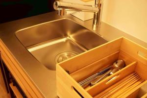 a stainless steel sink in a kitchen with a drawer at 小宿 和Nagomi in Kobe +25 photos