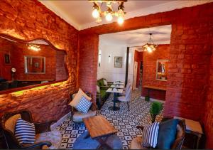 a living room with a brick wall at 1826 Heritage Rooms in Taksim