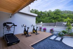 a patio with two exercise bikes on a deck at Fenghuang Story Hotel in Fenghuang County