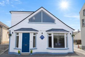 a blue and white house with a blue door at The Boutique Bungalow in Bundoran