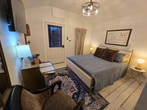 a bedroom with a bed and a couch and a chair at Roots Retreat in Seymour +53 photos