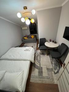 a small bedroom with a bed and a table and chairs at Гостиница 888 in Zhezdi