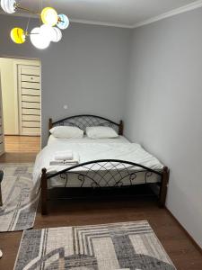 a bedroom with a large bed with a rug at Гостиница 888 in Zhezdi +9 photos
