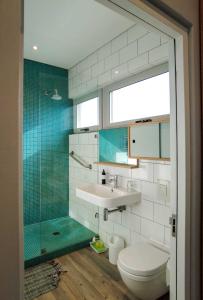 a bathroom with a toilet and a sink and a shower at Bokkombaai in Bloubergstrand +106 photos