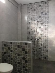 a bathroom with a toilet and a shower at Tafoukt House in Aourir +43 photos