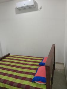 a bedroom with a bed with a air conditioner at Jaya Rest house in Unawatuna