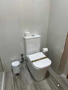 a bathroom with a toilet in a room at Mini Peixcateria A in Sagunto +6 photos
