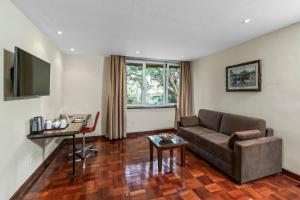 a living room with a couch and a table at Best Western Nairobi Upper Hill in Nairobi