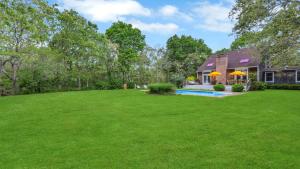 a house with a large yard with a swimming pool at Villa Willow & Waves in East Hampton