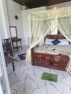 a bedroom with a bed with a canopy at SEENBEST Ella in Ella