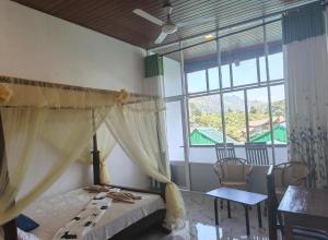 a bedroom with a bed and a large window at SEENBEST Ella in Ella