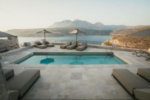 a swimming pool with a view of the water at Nest Limeni in Limeni