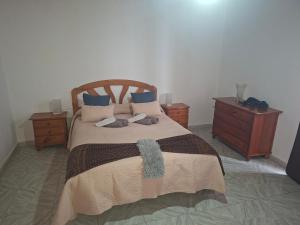 a bedroom with a large bed with two night stands at Solo Tranquilidad in Mocanal