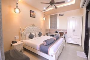 a bedroom with a large bed and a desk at Shree Ganesha Palace Near Kashi Vishwanath Temple in Varanasi