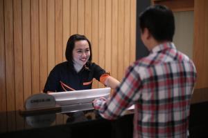a woman standing in front of a table with a man at Imperial Riverbank Hotel Kuching in Kuching