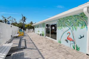 a building with a mural of a pink flamingo at Seashells #42 in Ybel