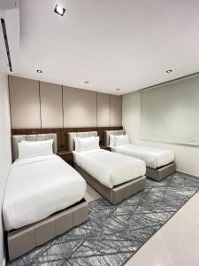a bedroom with two beds and a projection screen at اورا بلس AURA PALACe in Taif