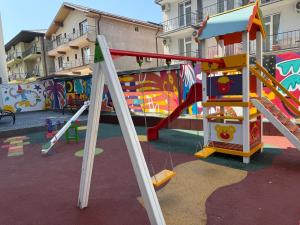 a playground with a slide and a play equipment at David Studio Nord Residence 2 in Eforie Nord +3 photos