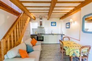 a living room with a white couch and a table at Eloi Merle Gîtes in Olonzac