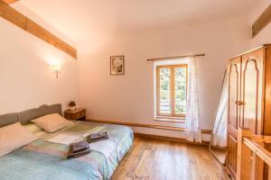 a bedroom with a bed and a window at Eloi Merle Gîtes in Olonzac +28 photos