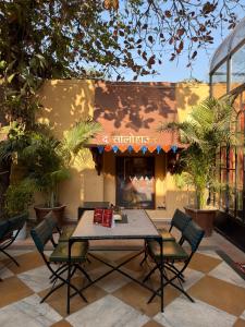 a patio with a table and chairs in front of a store at The Solo House in Jodhpur