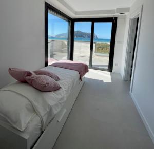 a bedroom with a bed with a view of the ocean at Lujosa casa en primera línea playa increibles vistas mar in Laredo