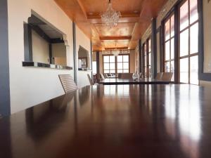 a large dining room with a large table and chairs at Jenny's Villa and Restaurant in Tuktuk Siadong