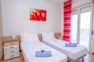 a bedroom with two beds and a window at Residence Playa Sirena in Tortoreto Lido +31 photos