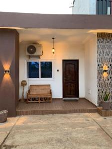 a porch with a bench and a window at Studio de luxe avec jacuzzi in Porto-Novo