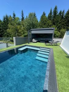 a swimming pool in the backyard of a house at Villa Ossiacher Tauern in Feldkirchen in Kärnten