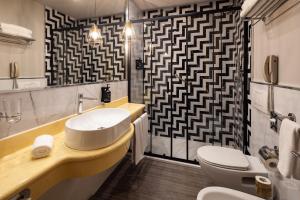 a bathroom with a sink and a toilet at Holiday Inn Milan Garibaldi Station by IHG in Milan