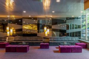 a lobby with purple chairs and a waiting room at HF Ipanema Porto in Porto
